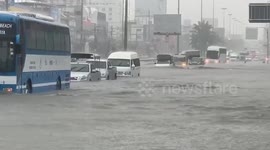 Cars travel through flooded roads in Thai city
