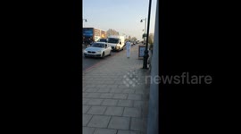Enthusiastic man performs dance routine across Kew Bridge in London
