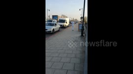 Enthusiastic man performs dance routine across Kew Bridge in London