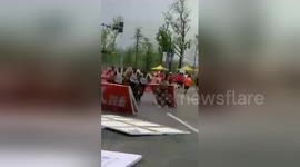 Chopper flying too low blows bollards into path of marathon runners in China