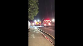 Fireman Rush to Chop and Saw Down a Fence to Put Out a Fire in Los Angeles