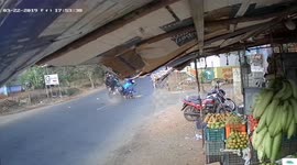 Horrific moment two mopeds smash together in the middle of a busy road
