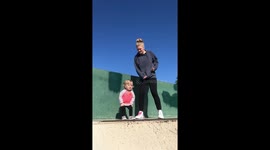 1 year old baby girl dancing with mom at skatepark