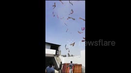 Hundreds of saris sent flying by high winds in eerie clip from west India