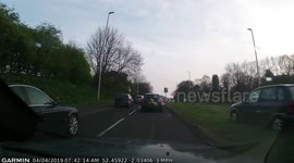 'What is he doing?' Moment impatient UK driver mounts grassy bank to avoid rush-hour traffic