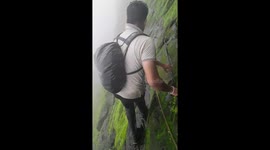 Trekker shows off terrifyingly slippery climb along cliff edge in west India