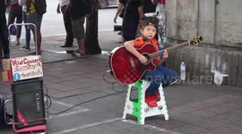 Street musicians of Thailand - the little guitarist in red red shoes