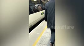 Rush hour commuters were forced to disembark through thick smoke after a packed train caught fire at one of Britain's busiest stations