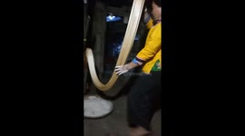 Vietnamese woman stretches out gooey traditional candy