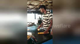 Indian paratha cook casually tosses dough over his shoulder to other chef