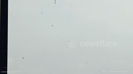 a number of paratroopers pierced the dark clouds above the sky of Juanda Airport, Surabaya