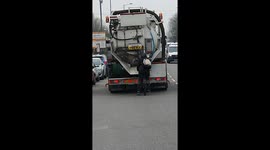 Jaw-dropping moment cyclist hitches a lift by hanging onto back of moving truck