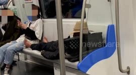 Old Chinese man sleeping barefoot on train seats attacks young man asking if he's well