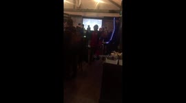 Barcelona wins: man in pub celebrates with mini speakerphone and flag