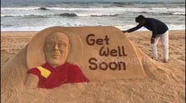 Sand artist in India carves 'Get Well' message for recently ill Dalai Lama