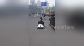 Miniature motorist? Chinese man drives go-kart along busy road