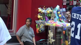 Tourists buy water guns and floral shirts for Thailand's Songkran new year festival
