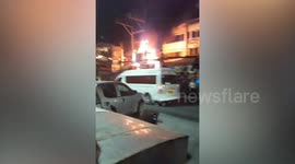 Fire rips through buildings as thousands of tourists splash water in Thai new year celebrations