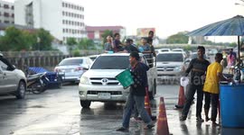 Thai New Year celebrations in the street, Thai people splashing water at passing motorists, during their  Songkran festival.