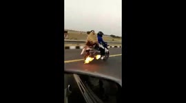 Indian family rides down highway on burning motorbike
