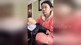 Mum pretends to watch TV to avoid being caught eating by greedy son