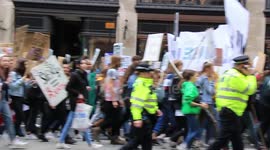 Climate change activists march through the streets of London
