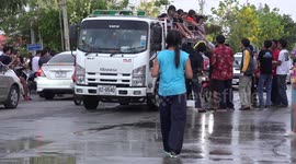 A truck full of pretty girls gets splashed with water during Thai New Year celebrations.