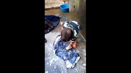 The three-year-old boy helps mother wash clothes