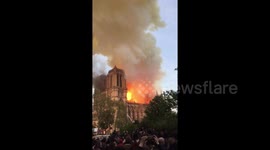 Crowd watches as flames engulf centuries-old cathedral in Paris