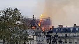 Crowds watch as Notre Dame fire tears through rooftop