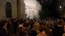 People in chorus near Notre Dame Cathedral in Paris while burning .
