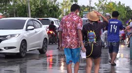 Thai people having fun splashing water in the street in celebration of their Songkran festival.