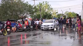 Thai people celebrating Songkran festival, everything gets splashed, even a passing bus.