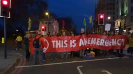 Extinction Rebellion climate change protesters hold 'This is an emergency' banner at London's Marble Arch
