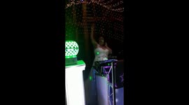 Bride playing Living On A Prayer by Bon Jovi at her wedding as DJ for photo & video opportunity