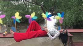 Thai lady lying down relaxing with wind mills and computer tablet.