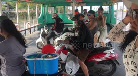 Motorbikes driving off ferry at Bang Nam Phueng Bangkok