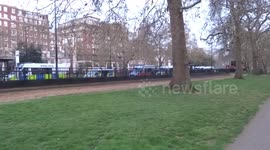 Metropolitan Police vehicles parked along Park Lane next to the Extinction Rebellion Marble Arch camp