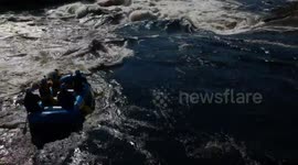 White water raft carrying 5 people is flipped over by huge wave on Gatineau River, Canada