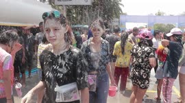 Revellers cover themselves in flour on Thai New Year celebrations