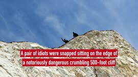 Pair snapped sitting on the edge of notoriously dangerous 500-foot cliff