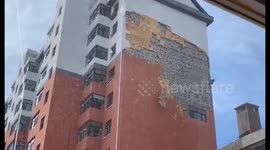 Wild winds rip off external wall on building in northeastern China