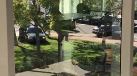 Dana point armed bank robbery car chase shootout.  Guy is held out in white truck.  Police have guns drawn.
