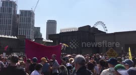 Climate change protesters singing after agreeing to leave Waterloo Bridge