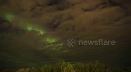 Stunning aurora borealis shines through cloudy night in Canada
