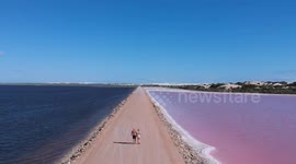 Drone footage captures incredible walk along Pink Lake in south Australia
