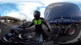 360 footage of a motorcyclist riding or filtering through traffic