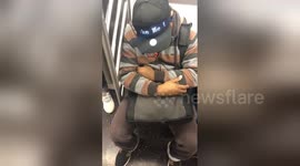US man wears ingenious hat which asks people to 'Wake him up before 34th Street'