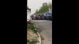 Bizarre moment moped riders patiently drive behind van spraying water in China
