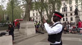 Heritage warden takes photos of cherry trees installed next to Millicent Fawcett statue in Parliament Square by Extinction Rebellion climate change activists